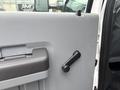 Close-up of the door handle and window crank of a 2014 Ford F-550 truck door