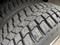 Close-up of a tire with a rugged tread pattern designed for traction and durability on a 2018 Ford Econoline