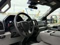 Interior view of a 2020 Ford F-550 featuring a steering wheel dashboard controls and a center console