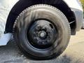Close-up of a black tire mounted on a 2013 International CE300 with visible wheel bolts and tread pattern