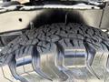 Close-up of a rugged tire tread of a 2013 RAM 2500 showcasing deep grooves and bold patterns designed for off-road performance
