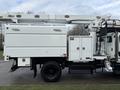 A 2015 Freightliner M2 bucket truck equipped with an Altec aerial lift and utility storage compartments on the side