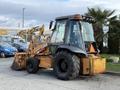 A 2005 Case 570 tractor with a front loader and large tires, featuring a transparent cabin and orange and black color scheme