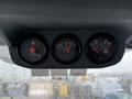Dash display of a 2011 Ford F-650 featuring three round gauges showing hour meter oil pressure and engine temperature