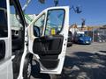 A 2020 RAM ProMaster 3500 with its driver side door open displaying a spacious interior and modern controls