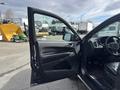 A 2015 Dodge Durango with an open driver's side door showcasing the interior features and seating