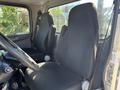 Interior of a 2020 Peterbilt 330 showing two fabric-covered seats and steering wheel