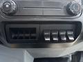Control panel of a 2015 Ford F-750 featuring switches for auxiliary functions and climate control knobs