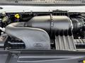 Close-up of the engine compartment of a 2013 Ford Econoline showing the air intake and various engine components
