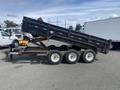 A 2009 Load 16 foot Dump Trailer with a raised bed and black exterior showcasing wheels and a tow hitch