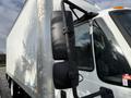 A 2014 International TerraStar truck with a large white cargo box and prominent side mirrors in the foreground