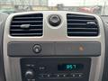 Dashboard controls and air vents of a 2011 Chevrolet Colorado featuring audio and climate controls with a digital clock displaying 8 57