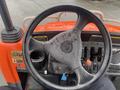 View of the steering wheel and dashboard of a 2010 Kubota RTV 900 with visible controls and a key attached to the ignition