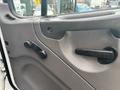 Interior door panel of a 2006 Freightliner M2 106 featuring a door handle and window controls