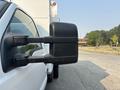 Close-up of the side mirror of a white 2009 Ford F-550 showcasing its design and structure