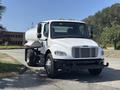 A 2014 Freightliner M2 106 truck primarily used for transporting liquids with a white cab and a large cylindrical tank mounted on the rear
