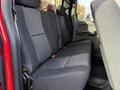Interior view of the backseat of a 2013 Chevrolet Silverado 3500HD featuring black fabric upholstery and two seatbelts visible on the bench seat