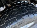 Close-up of a tread pattern on a tire from a 2020 Ford F-350 showcasing deep grooves for traction and a rugged design
