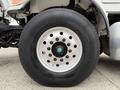 A close-up of a wheel from a 2016 Peterbilt 348 featuring a silver aluminum rim and a large Michelin tire with deep treads