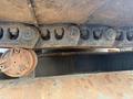 Close-up of a rusty track and undercarriage of a 2018 Caterpillar 326F L Excavator showing worn links and metal components