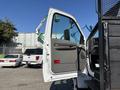 A 2004 Ford F-750 with an open door displaying the interior and driver's seat