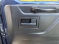 The interior door handle of a 2016 Ford Transit 150 with a textured black finish and a simple rectangular design