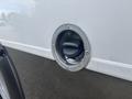 Fuel filler cap of a 2020 Chevrolet Express with a circular design and a spring-loaded cover