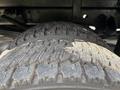 Close-up of two heavily worn tires from a 2016 RAM 5500 showing significant tread wear and dirt accumulation