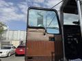 The image shows the open door of a 1996 Kenworth T800 truck with brown paneling and a view into the interior featuring controls and a steering wheel