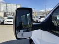 A 2017 Chevrolet Express van with a side mirror prominently displayed
