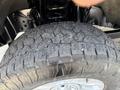 Close-up of a rugged tire from a 2020 Ford F-350 SD showcasing deep treads and substantial wear on the rubber surface