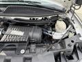 A 2020 Chevrolet Express engine showcasing components like the air intake system cooling reservoir and various hoses
