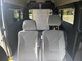 Interior view of a 2022 RAM Promaster 350 featuring two grey fabric front seats with headrests and a partition behind them