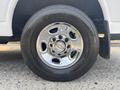 Close-up of a chrome wheel on a 2021 Chevrolet Express featuring five lug nut holes and a prominent Chevrolet emblem in the center