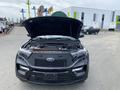 A black 2021 Ford Explorer with its hood raised showcasing the engine compartment