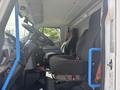 Interior view of a 2020 Lion Lion6 showing two black fabric seats and a dashboard with controls and a steering wheel