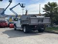 A white 2013 RAM 5500 with a metal flatbed and rear hitch is parked with its back facing the viewer