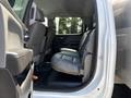 Interior of a 2020 Chevrolet Silverado showing the back seat area with gray leather seats and a spacious cabin layout