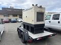 A 2005 Katolight SED60FPJ4 generator mounted on a trailer with a black base and white body featuring vents on the side and a control panel on the front