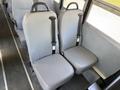 Two gray vinyl seats with safety belts designed for a school bus interior