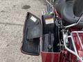 A 2009 Harley-Davidson Road King with an open saddlebags revealing a black interior and tool storage compartment
