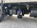 A 2018 Hino 195 with a black fuel tank under the chassis featuring a blue cap and connected components for the vehicle's systems