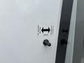 A label on a 2020 Chevrolet Express indicating how to open and close the door with arrows pointing to the left and right