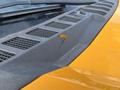 Close-up of a chipped section on the dashboard of a yellow 2017 Ford F-250 SD showing wear and a small crack in the material