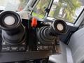 Control panel with joysticks and buttons labeled for operations on a 2016 International 7600
