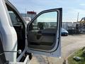 A 2022 Ford F600 with an open driver's side door showing a gray interior and an armrest