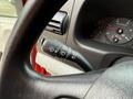Close-up of the steering wheel and control stalk of a 2007 Ford F-550 displaying the wiper and turn signal controls