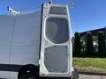 A side view of a 2024 Mercedes-Benz Sprinter 2500 with an open rear door revealing a gray interior panel and hinges