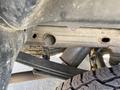 View of the undercarriage of a 2014 GMC Sierra 1500 showing metal framework tires and suspension components