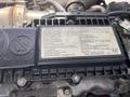 A close-up view of a Hino 195 engine component featuring a black information plate with various technical details and warning instructions